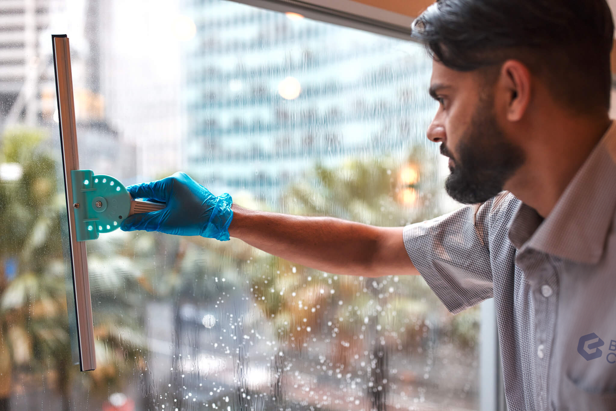 Staff cleaning workplace windows