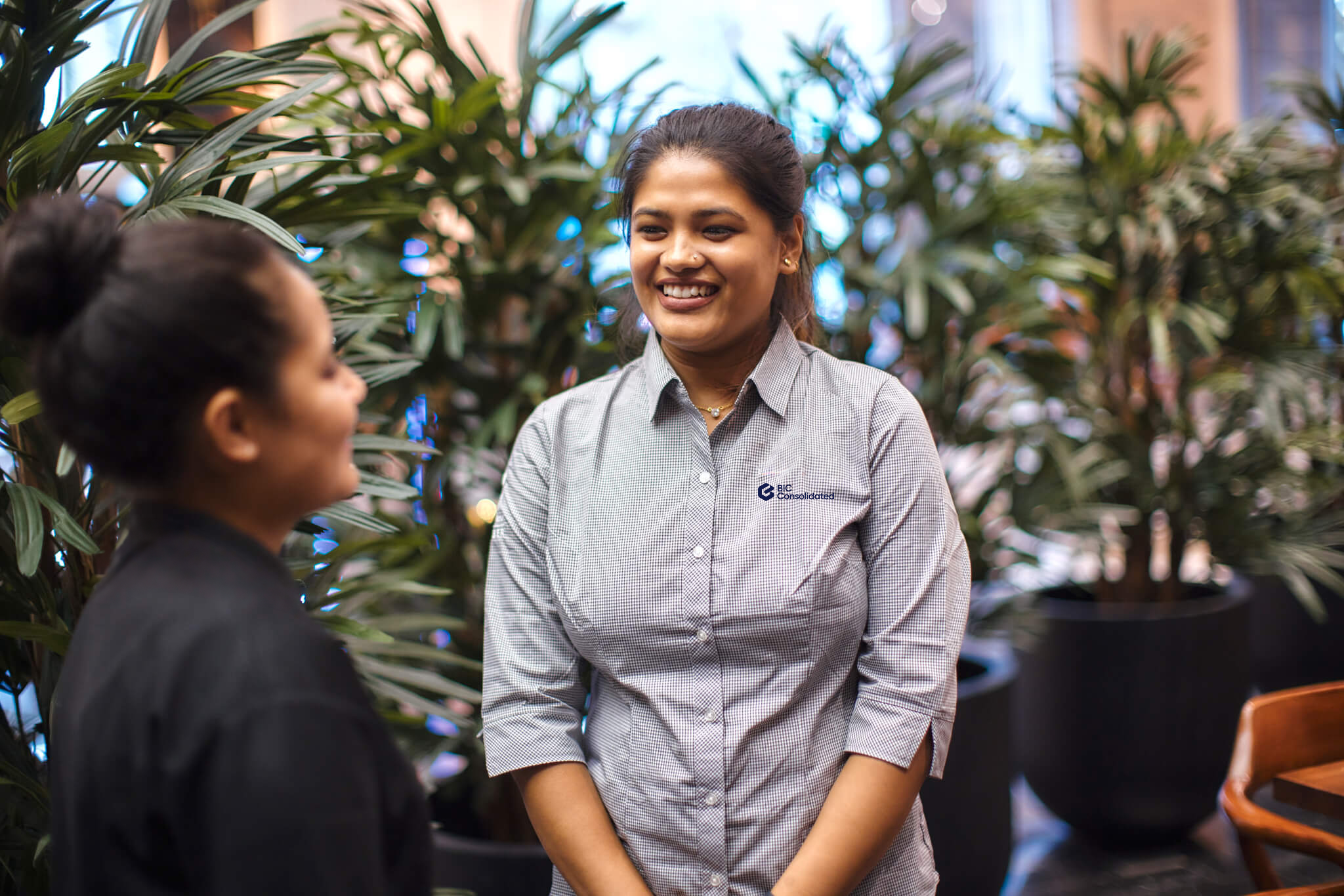 Two cleaners discussing workplace standards